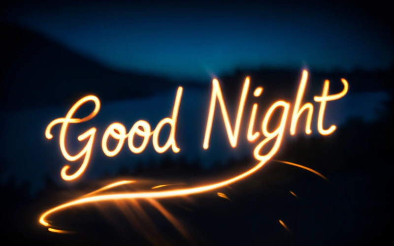 A blurry photo of a sign that says good night with a blurry background of trees and a mountain in the distance with a blue sky, night, a 3d render, video art