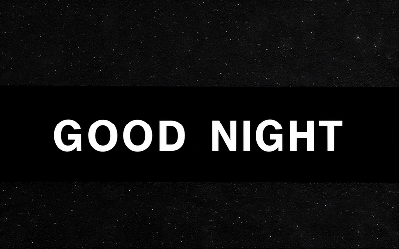 A black and white photo with the words good night written in white on a black background with stars in the sky above it and below, night, a cross stitch, video art