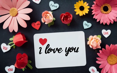 A card with i love you written on it surrounded by flowers and hearts on a black background with a white card with i love you written on it, love, a stock photo, romanticism